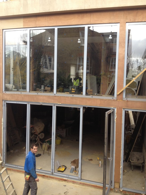 Aluminium bi-fold doors with two-storey glazing in West Brompton